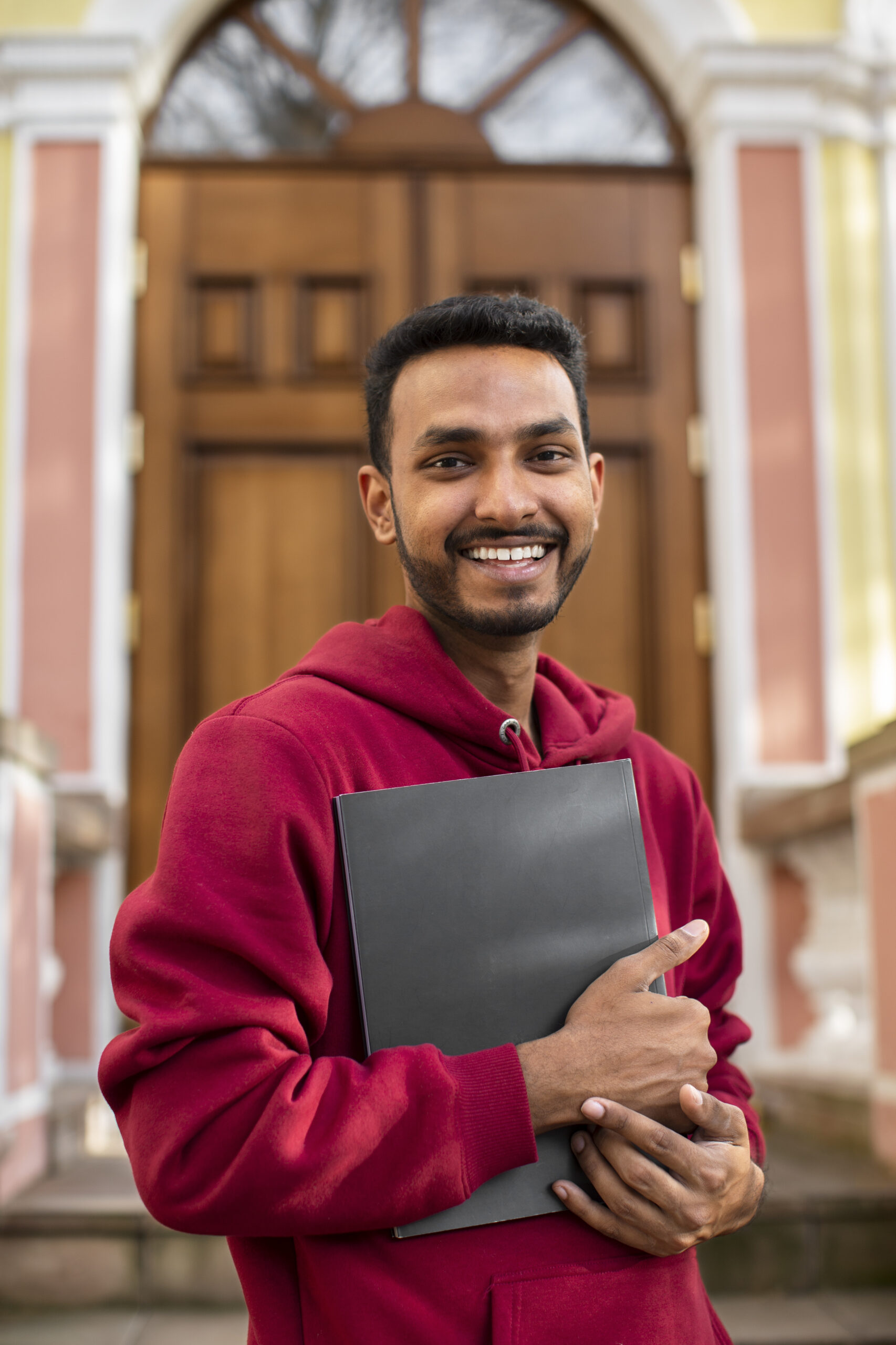 front-view-smiley-man-holding-book